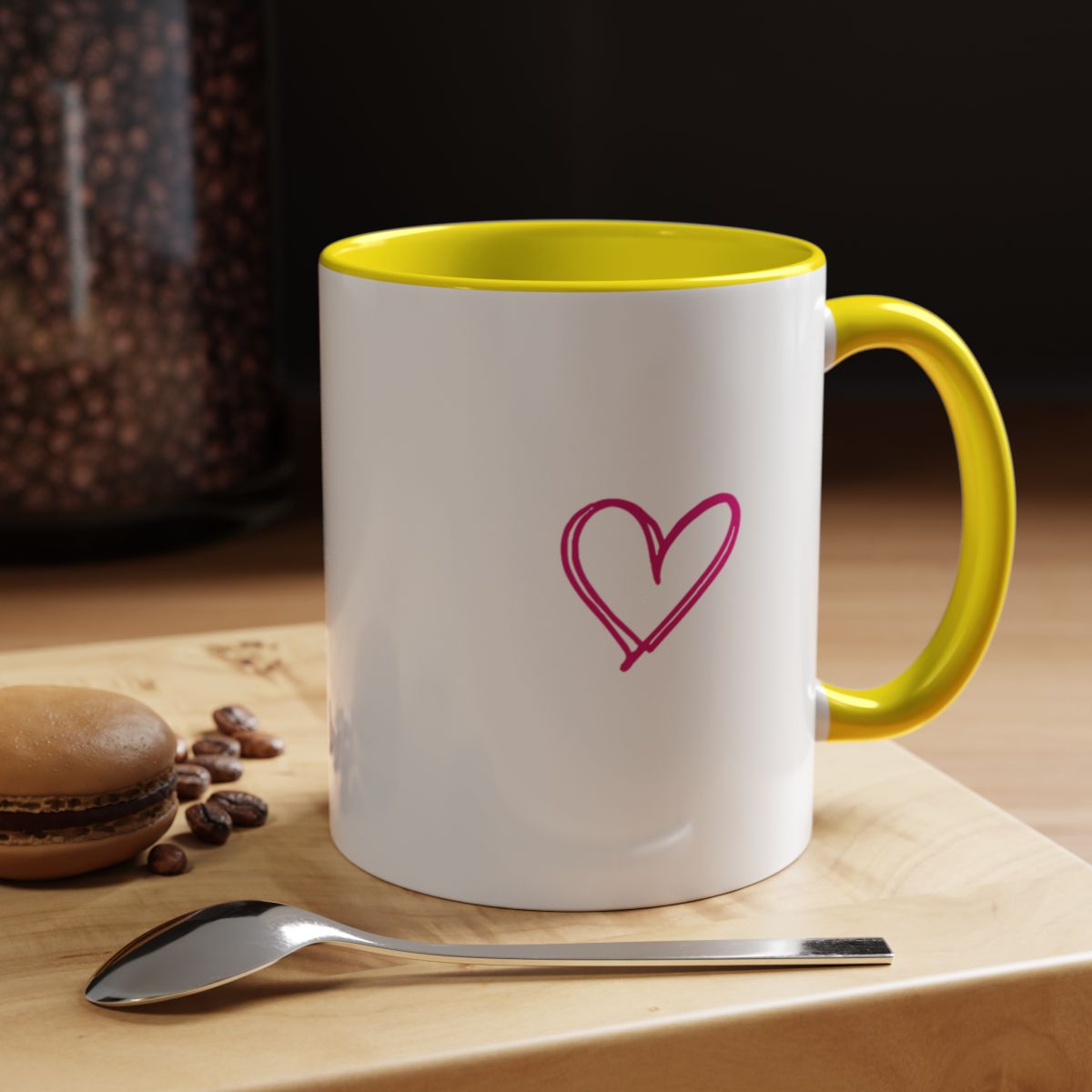 CEO Vibes coffee mug with yellow interior and handle on a wooden table, pink heart side showing