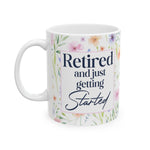 Retired and Just Getting Started mug with watercolor floral wrap, front view with navy "Retired" and script "Started"
